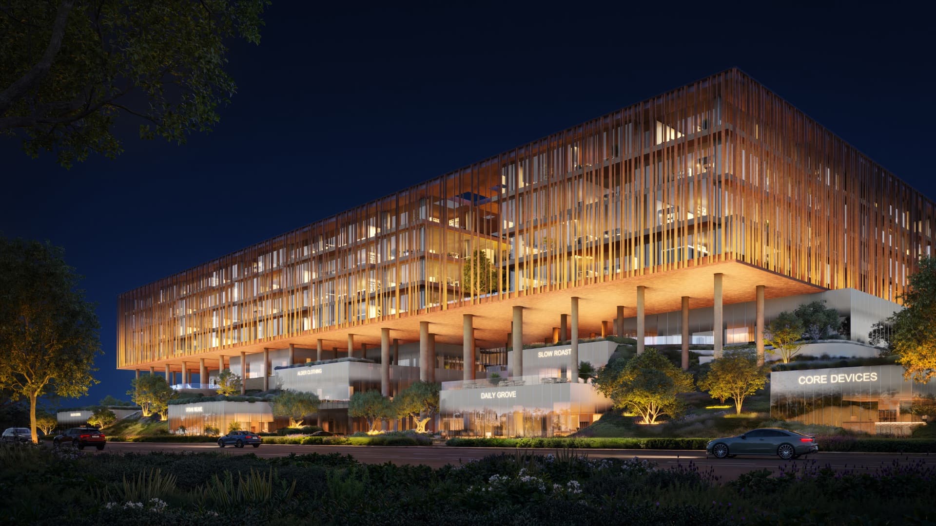 Street view of The Yards Plaza by night in City of Arabia, Dubai